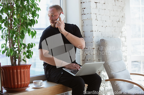 Image of Young man studying at home during online courses for analytics, financists, economists