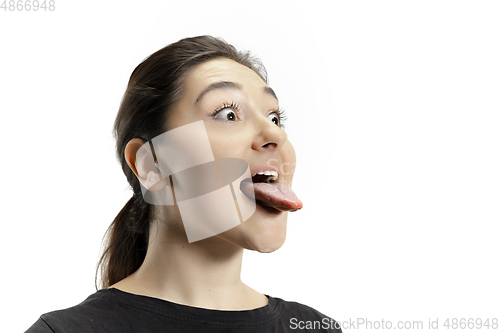 Image of Smiling girl opening her mouth and showing the long big giant tongue isolated on white background, crazy and attracted