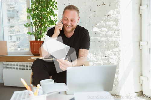 Image of Young man studying at home during online courses for managers, marketers, buyers