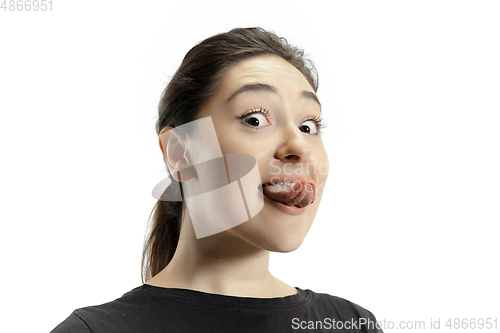 Image of Smiling girl opening her mouth and showing the long big giant tongue isolated on white background, crazy and attracted