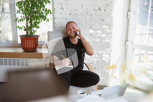 Image of Young man studying at home during online courses for managers, marketers, buyers