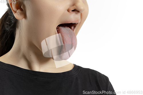 Image of Smiling girl opening her mouth and showing the long big giant tongue isolated on white background, crazy and attracted