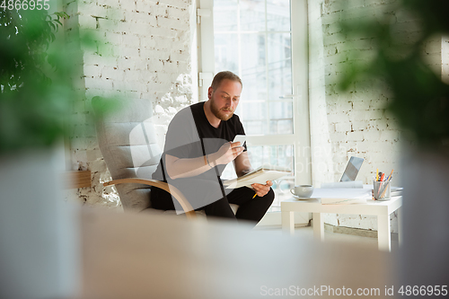 Image of Young man studying at home during online courses for managers, marketers, buyers