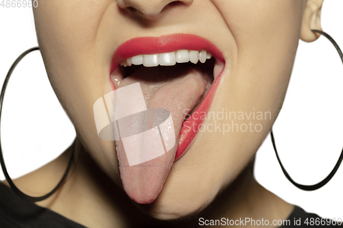 Image of Smiling girl opening her mouth with red lips and showing the long big giant tongue isolated on white background, crazy and attracted, close up