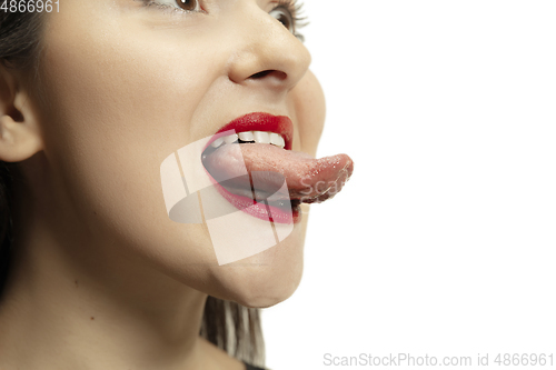 Image of Smiling girl opening her mouth with red lips and showing the long big giant tongue isolated on white background, crazy and attracted, close up