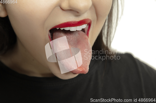 Image of Smiling girl opening her mouth with red lips and showing the long big giant tongue isolated on white background, crazy and attracted, close up