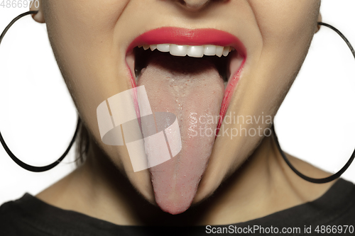 Image of Smiling girl opening her mouth with red lips and showing the long big giant tongue isolated on white background, crazy and attracted, close up