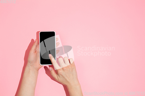 Image of Hand using gadget, device on top view, blank screen with copyspace, minimalistic style