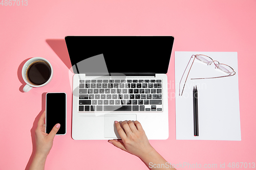 Image of Hand using gadgets, device on top view, blank screen with copyspace, minimalistic style