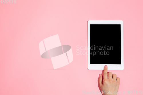 Image of Hand using gadget, device on top view, blank screen with copyspace, minimalistic style