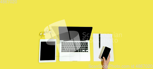 Image of Hand using gadgets, device on top view, blank screen with copyspace, minimalistic style, flyer