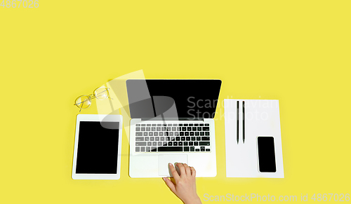 Image of Hand using gadgets, device on top view, blank screen with copyspace, minimalistic style, flyer