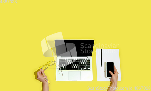 Image of Hand using gadgets, device on top view, blank screen with copyspace, minimalistic style, flyer