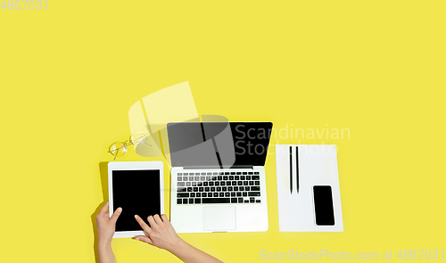 Image of Hand using gadgets, device on top view, blank screen with copyspace, minimalistic style, flyer