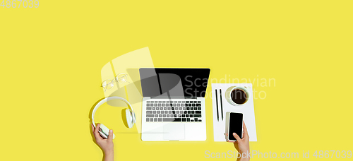 Image of Hand using gadgets, device on top view, blank screen with copyspace, minimalistic style, flyer