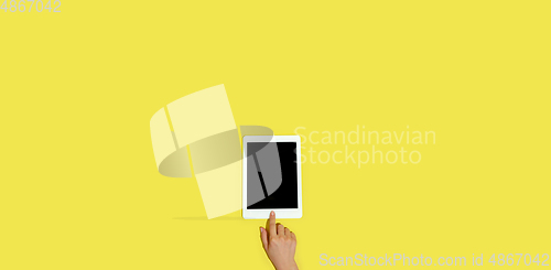 Image of Hand using gadgets, device on top view, blank screen with copyspace, minimalistic style, flyer