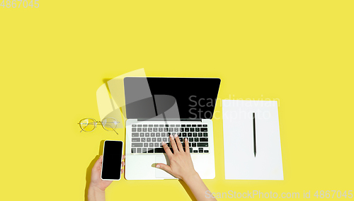 Image of Hand using gadgets, device on top view, blank screen with copyspace, minimalistic style, flyer