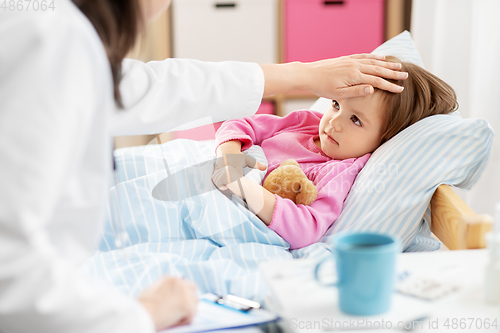 Image of doctor measuring sick girl's temperature at home