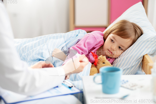 Image of doctor measuring sick girl's temperature at home