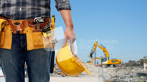 Image of worker or builder with helmet and working tools