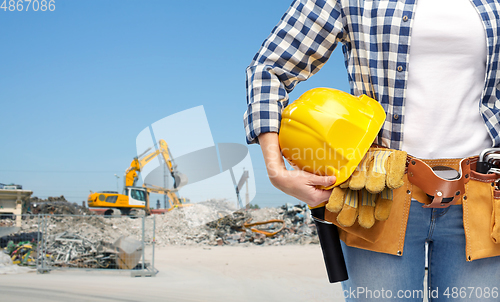 Image of woman or builder with helmet and working tools