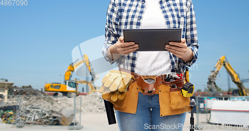 Image of woman or builder with tablet pc and working tools