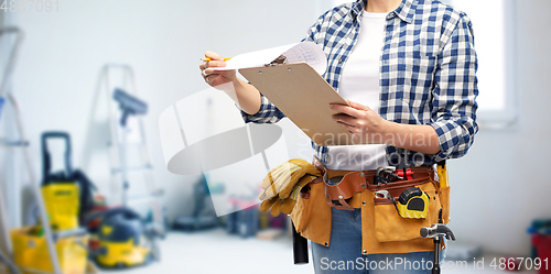 Image of woman with clipboard, pencil and working tools