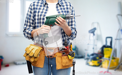 Image of woman or builder with drill and work tools
