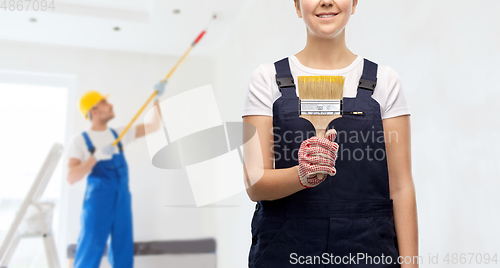 Image of close up of painter or builder with paint brush