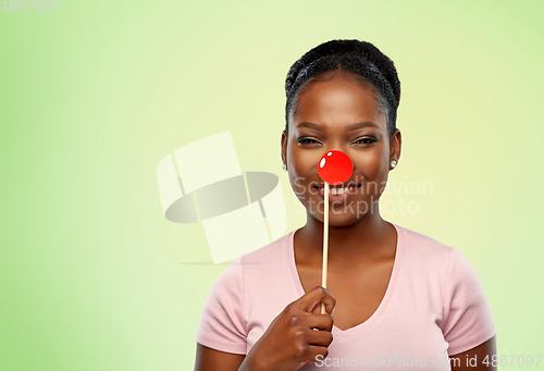 Image of happy african american woman with red clown nose