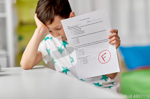 Image of sad student boy with failed school test at home