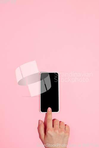 Image of Hand using gadget, device on top view, blank screen with copyspace, minimalistic style