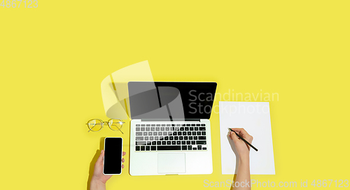 Image of Hand using gadgets, device on top view, blank screen with copyspace, minimalistic style, flyer