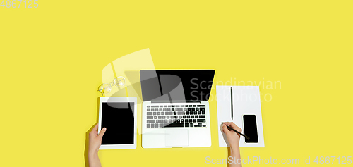 Image of Hand using gadgets, device on top view, blank screen with copyspace, minimalistic style, flyer