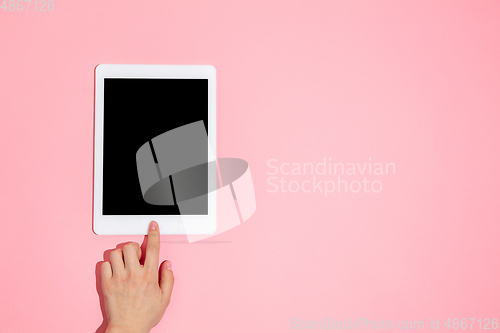 Image of Hand using gadget, device on top view, blank screen with copyspace, minimalistic style