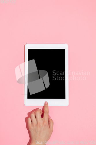 Image of Hand using gadgets, device on top view, blank screen with copyspace, minimalistic style