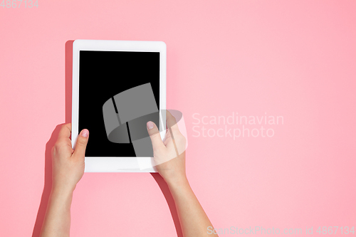 Image of Hand using gadget, device on top view, blank screen with copyspace, minimalistic style
