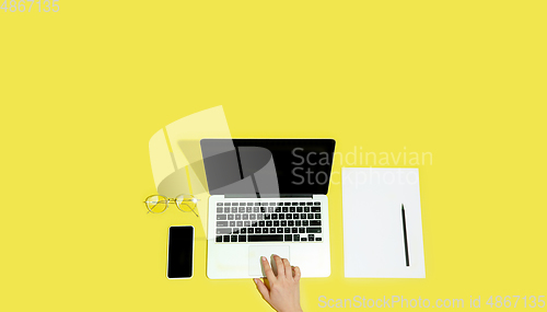 Image of Hand using gadgets, device on top view, blank screen with copyspace, minimalistic style, flyer