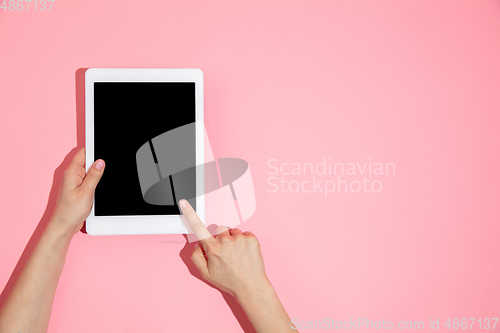 Image of Hand using gadget, device on top view, blank screen with copyspace, minimalistic style