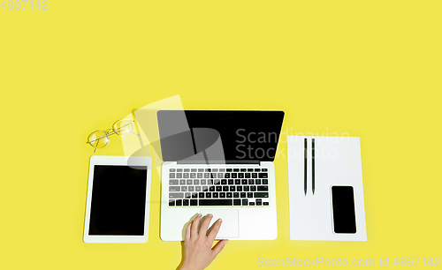 Image of Hand using gadgets, device on top view, blank screen with copyspace, minimalistic style, flyer