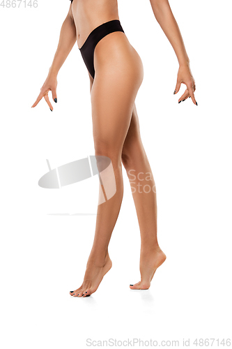 Image of Beautiful female legs isolated on white background. Beauty, cosmetics, spa, depilation, treatment and fitness concept, sensual posing