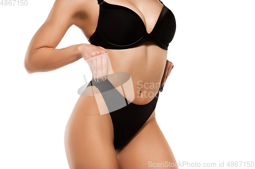 Image of Beautiful female legs isolated on white background. Beauty, cosmetics, spa, depilation, treatment and fitness concept, sensual posing