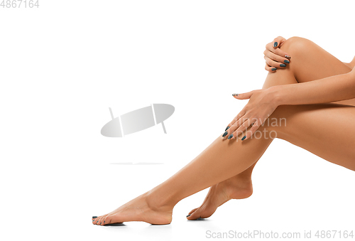 Image of Beautiful female legs isolated on white background. Beauty, cosmetics, spa, depilation, treatment and fitness concept, sensual posing