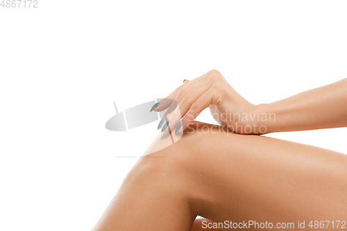 Image of Beautiful female legs isolated on white background. Beauty, cosmetics, spa, depilation, treatment and fitness concept, sensual posing