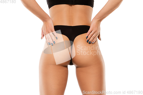 Image of Beautiful female back and buttlocks isolated on white background. Beauty, cosmetics, spa, depilation, treatment and fitness concept, sensual posing