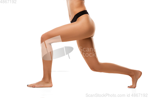 Image of Beautiful female legs isolated on white background. Beauty, cosmetics, spa, depilation, treatment and fitness concept, training, in action