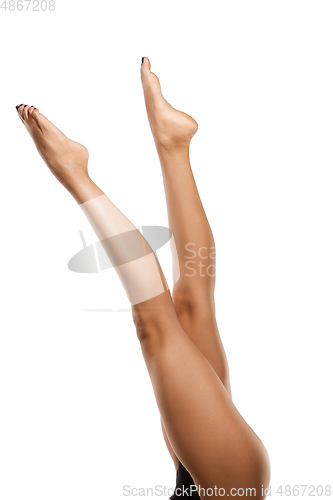 Image of Beautiful female legs isolated on white background. Beauty, cosmetics, spa, depilation, treatment and fitness concept, sensual posing