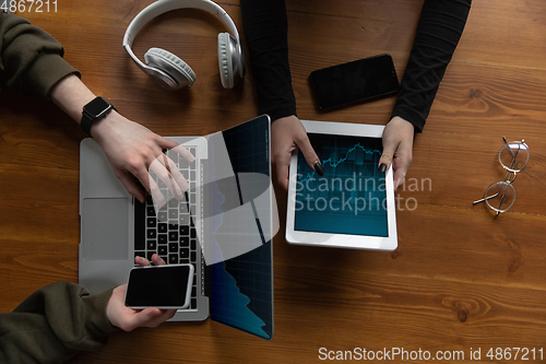 Image of Close up of two people, couple using smartphone, laptop, smartwatch, education and business concept. Communication during self-insulation, top view, copyspace