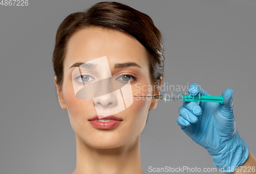 Image of beautiful young woman and hand with syringe