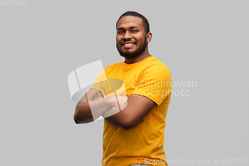 Image of smiling african american man with crossed arms